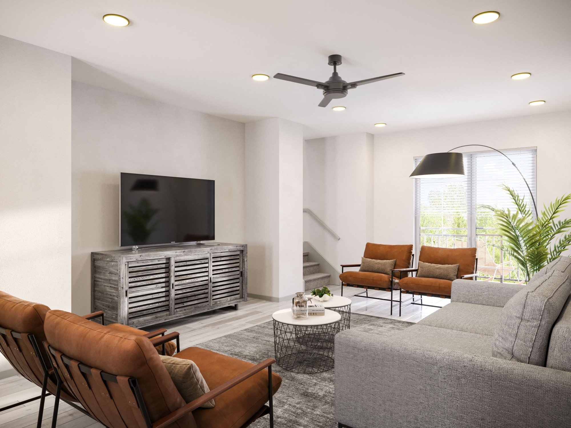 Spacious living room with modern furniture, ceiling fan, large open windows and access to upstairs